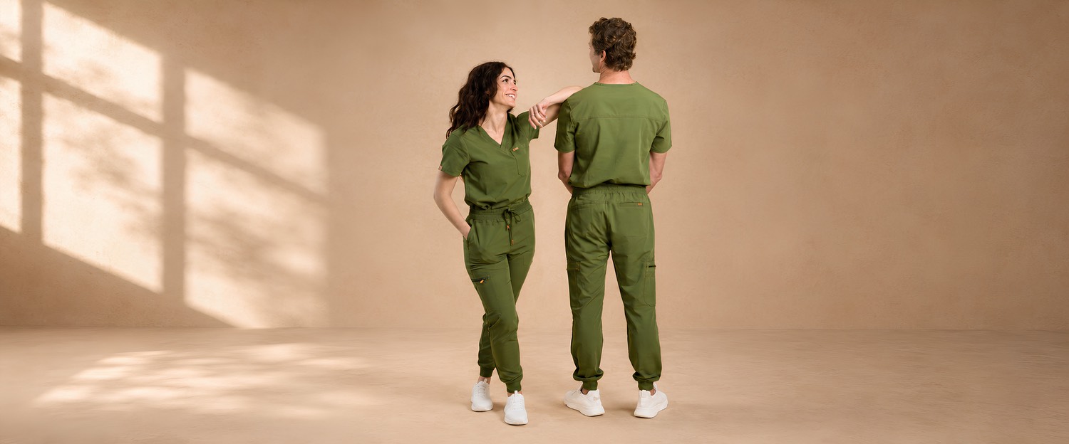 Two healthcare workers in SALT olive scrubs